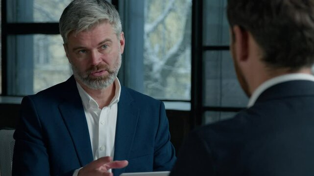 Caucasian man businessman ceo hr director having interview meeting hiring recruit at job male applicant in office consultant manager advising client men businessmen communicate at business negotiation