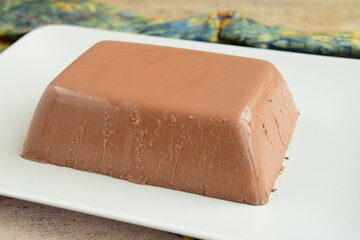 Dark chocolate milk pudding cake served on a plate. Selective focus