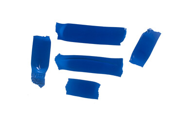 set of torn blue rubber pieces of electrical tape glued to a white background, close up