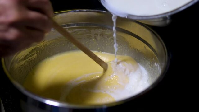 man cooking at home top view spreading white cream on the puff pastry layers to prepare a Napoleon cake. cooking process step by step. Cooking With Love For Family Male Hairy Hands