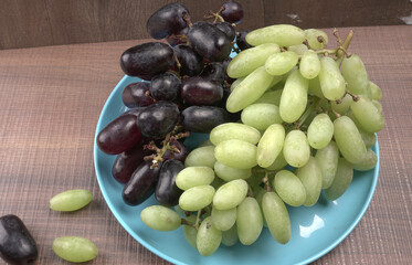 Natural organic different types of fresh ripe juicy grapes and space for text on table. top view, Agriculture concepts.
