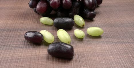 Natural organic different types of fresh ripe juicy grapes and space for text on table. top view, Agriculture concepts.