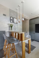 Modern Grey Kitchen with Wooden Elements and Dining Space