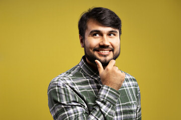 man with hand on chin, smiling and looking to the side