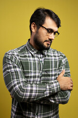 man in glasses with arms crossed looking down