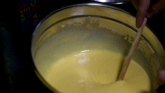 man cooking at home top view spreading white cream on the puff pastry layers to prepare a Napoleon cake. cooking process step by step. Cooking With Love For Family Male Hairy Hands