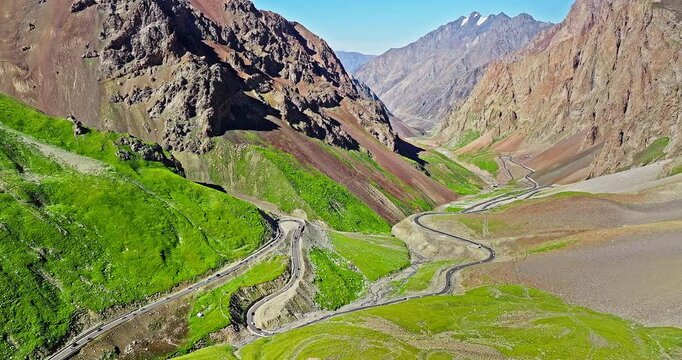 Winding asphalt highway road in the valley. Spectacular Duku highway and mountain natural landscape in Xinjiang. Duku highway is the most beautiful highway in China.