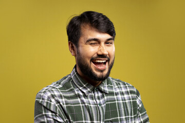 Obraz premium man winking, with an open smile and looking at the camera