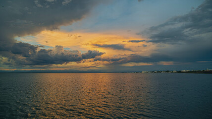Cloudy sunset. View from the coast towards sea. Italy.