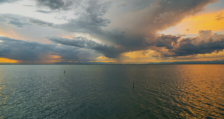 Cloudy sunset. View from the coast towards sea. Italy.