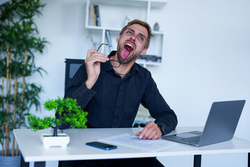 A man crazy at the office. Businessman exhausted from work.