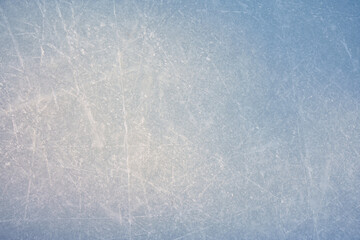 An ice surface as an ice rink with ice skates tracks. Winter sports texture.