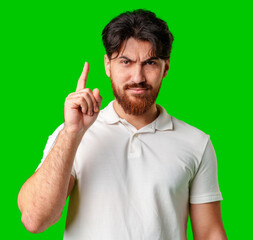 A man contemplates thoughtfully against a bright green background