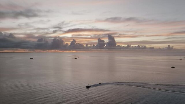 Aerial footage of tropical sunset on an siland withj ocean and boats. Mauritius