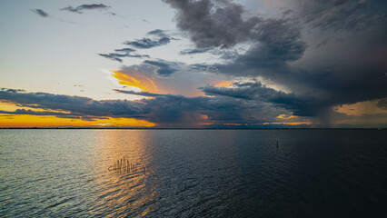 Cloudy sunset. View from the coast towards sea. Italy.