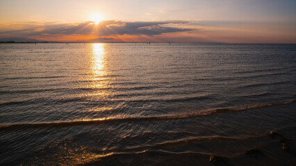 Cloudy sunset. View from the coast towards sea. Italy.