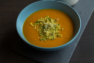 Carrot Soup with Coconut in a Blue Bowl - Close-Up