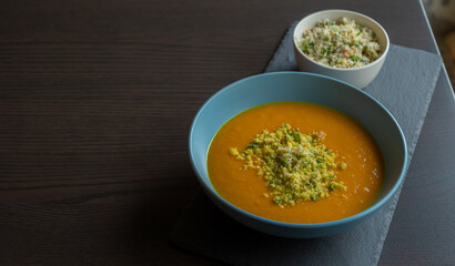 Carrot Soup with Coconut in a Blue Bowl - Close-Up