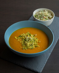 Carrot Soup with Coconut in a Blue Bowl - Close-Up