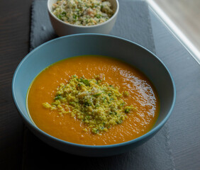 Carrot Soup with Coconut in a Blue Bowl - Close-Up