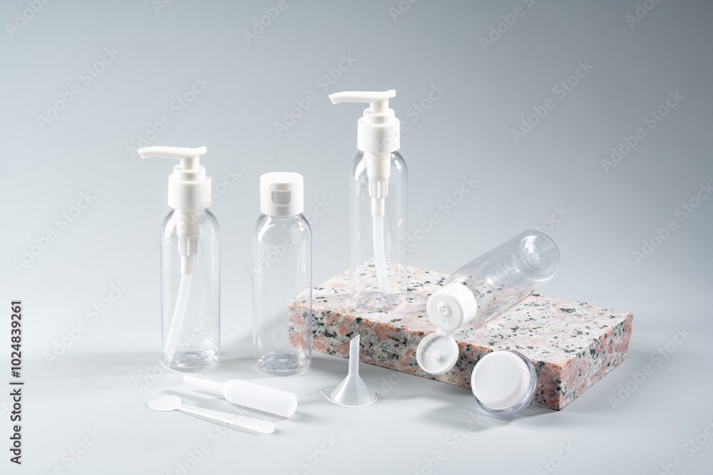 Poster elegant amber glass bottles displayed on a textured stone surface in a minimalist studio setting