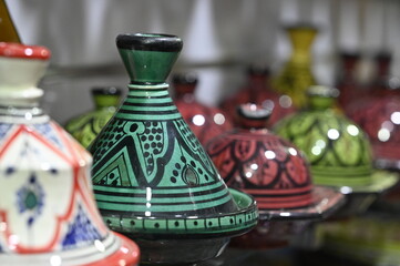 Traditional Moroccan Tagine Pot : A beautifully handcrafted Moroccan tagine pot, made from natural clay and painted with traditional Berber designs.