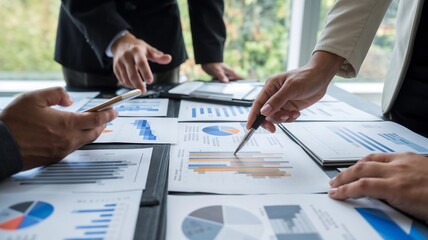 People Working In Office, Business Professionals Analyzing Data Reports, Holding Smart Phone With Data Reports On Table.