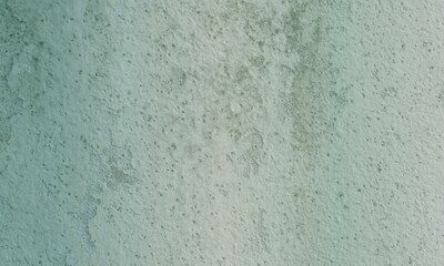 A textured backdrop featuring a blend of green and white wall surfaces, showcasing an aged, grunge appearance with a vintage feel