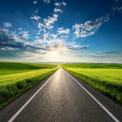 asphalt road in green fields under beautiful sky