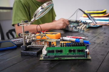 Engineer, a precise computer motherboard repair technician, uses a screwdriver to change parts, focuses on technology maintenance, repairs electronic devices, and supports ideas.