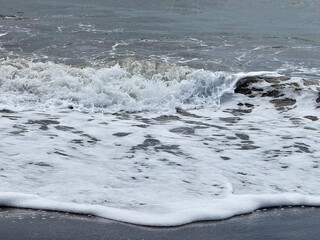 close-up of a wave with its foam in a rough sea

