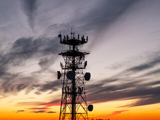 5G Cellular tower at sunset with colored skies