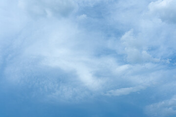 Fluffy white clouds drift across a clear blue sky, painting a breathtaking canvas of nature's beauty