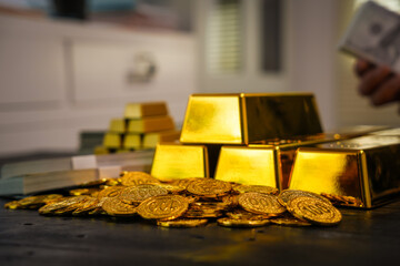 Businessman doing online gold transactions emphasizes the convenience of investing in digital gold. Businessman holds shiny gold bars in office, symbolizing wealth and investment opportunities.