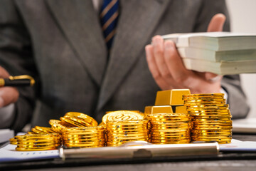 Businessman doing online gold transactions emphasizes the convenience of investing in digital gold. Businessman holds shiny gold bars in office, symbolizing wealth and investment opportunities.