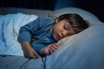 toddler baby sleeping on bed at night