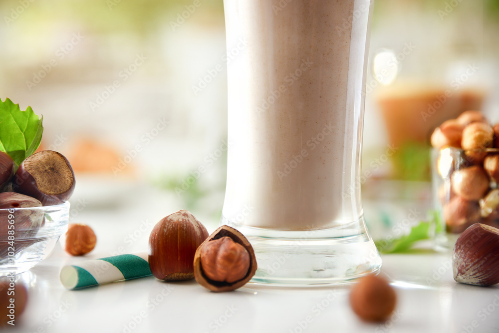 Wall mural detail of hazelnut smoothie with glass and nuts around it