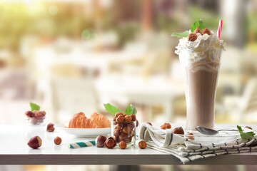 Milkshake with hazelnuts and cream decorated on a terrace