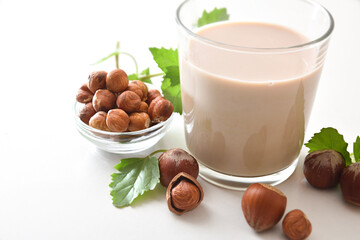 Detail of hazelnut drink in glass with fruits isolated