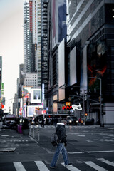 traffic in the New york city and a man crossing the road