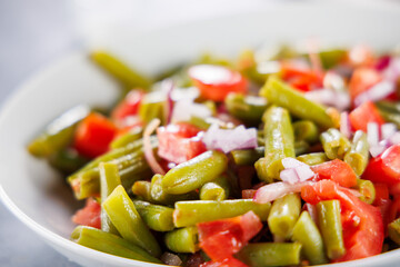 green bean salad with tomato and onion, up high