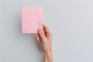 Hand Holding a Sheet of Sticky Note | Essential Tool for Organisation and Reminders in Everyday Life
