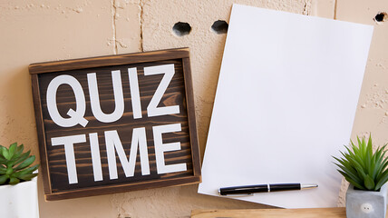 White text on brown wood sign, Quiz Time, fun, education, game night. 
