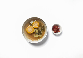 Sayur asam or sayur asem is popular soup in Indonesia. Served in a bowl with sambal. Isolated white background