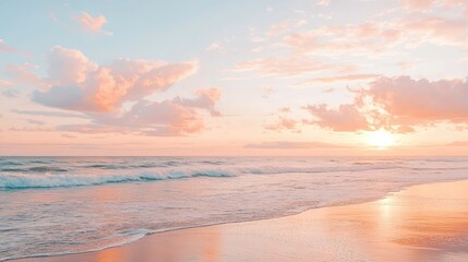 A serene beach at sunrise with gentle waves and the sky painted in shades of pink, orange, and gold.