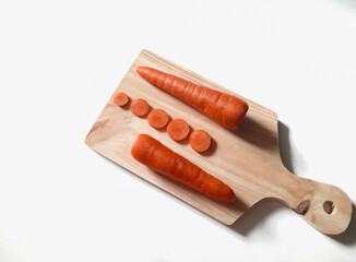Fresh carrots on the cutting board. Isolated background