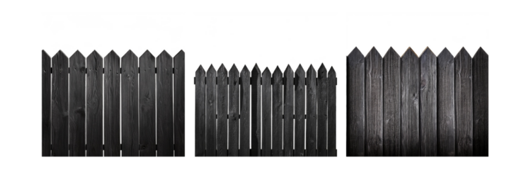 A black wooden fence with pointed tops and gaps in between.