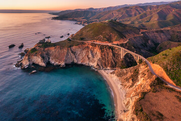 Fototapeta premium Bixby Bridge on Highway 1 and Big Sur along Pacific Ocean coast, beautiful landscape and aerial view, sunset, sunrise, fog. Concept, travel, vacation, weekend