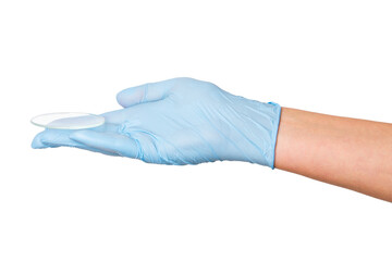 Hand in medical gloves holding a small Petri dish on an empty background. Laboratory use,...