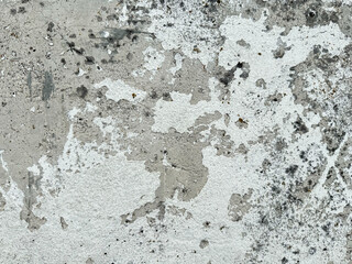 Textured weathered concrete wall with peeling paint and mold patterns